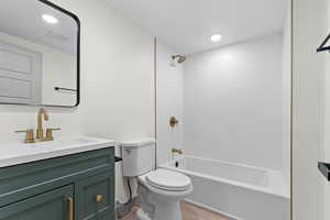 Bathroom with vanity, bathing tub / shower combination, and recessed lighting