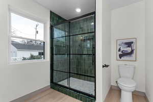 Bathroom featuring a stall shower and light wood-style flooring
