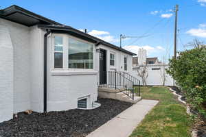 Entrance to property with brick siding