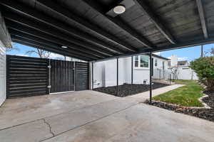 View of patio featuring a gate