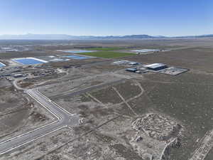 Aerial view of property's location featuring a mountainous background