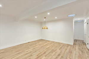 Empty room featuring crown molding, light wood finished floors, and recessed lighting