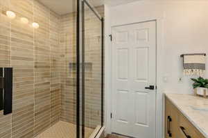 Full bathroom featuring vanity and a stall shower