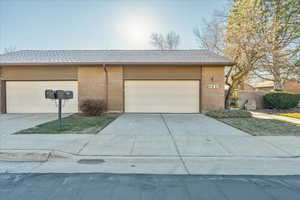 Garage featuring concrete driveway