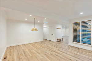 Spare room featuring ornamental molding, light wood finished floors, and recessed lighting