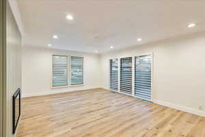 Unfurnished room with light wood finished floors, ornamental molding, and recessed lighting