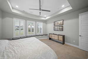 Bedroom featuring a tray ceiling, a ceiling fan, and recessed lighting