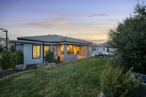 Back of property featuring stucco siding, a patio area, and a tile roof