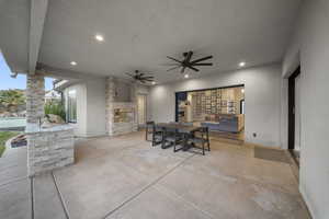 View of patio / terrace featuring ceiling fan, outdoor dining area, and an outdoor kitchen