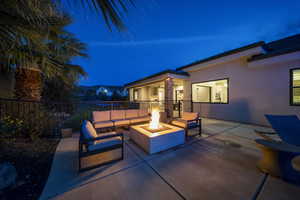 Patio at twilight with a patio and an outdoor living space with a fire pit