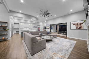 Living area with dark wood-style floors and recessed lighting