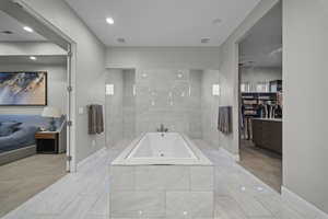 Full bathroom featuring a bath, a spacious closet, and ensuite bath