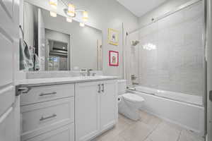 Full bathroom featuring vanity and shower / bath combination with glass door