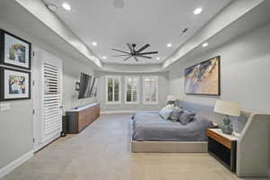 Bedroom featuring a tray ceiling, ceiling fan, and recessed lighting