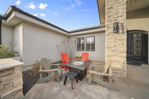 View of patio with an outdoor fire pit