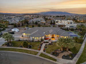View of front facade with a residential view, stucco siding, and a lawn