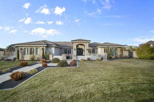 Prairie-style home featuring stone siding, a tile roof, and stucco siding