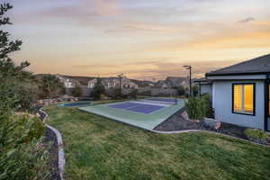 View of sport court with a residential view and a tennis court