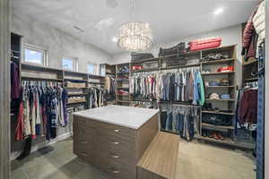 Walk in closet with a chandelier