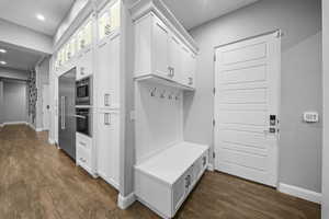 Mudroom featuring dark wood-style floors and recessed lighting