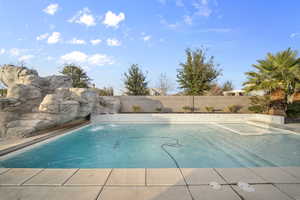 View of pool with a fenced backyard and a patio area