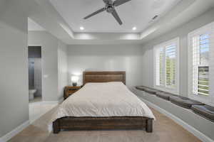 Bedroom with ceiling fan, recessed lighting, connected bathroom, and a tray ceiling