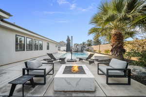 Fenced backyard featuring a patio and an outdoor fire pit