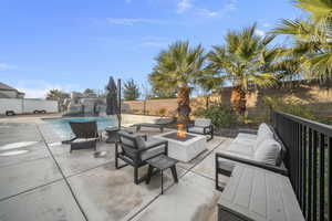 Fenced backyard with a patio area and an outdoor living space with a fire pit