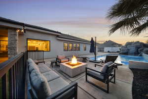 Fenced backyard featuring an outdoor fire pit and a patio area