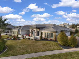 View of front of home with stone siding, stucco siding, and a tiled roof