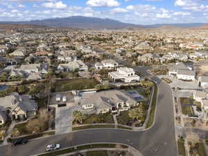 Aerial overview of property's location featuring nearby suburban area and a mountain backdrop