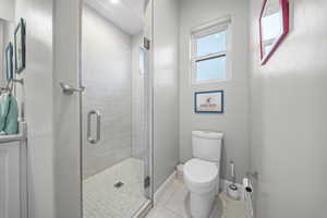 Full bathroom with a shower stall and toilet