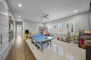 Playroom featuring healthy amount of natural light, recessed lighting, a ceiling fan, and light wood-style floors