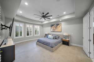 Bedroom featuring a tray ceiling, recessed lighting, and a ceiling fan