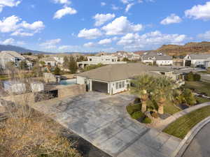 View of front of house with a residential view, driveway, and an attached garage