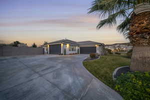 Prairie-style home featuring concrete driveway, an attached garage, and stucco siding