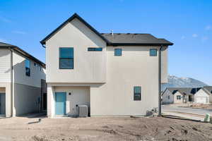 Back of property featuring a mountain view and stucco siding