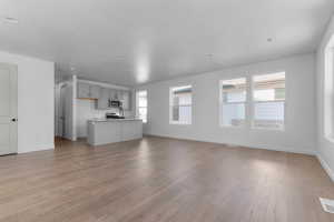 Unfurnished living room featuring light wood-style floors and recessed lighting