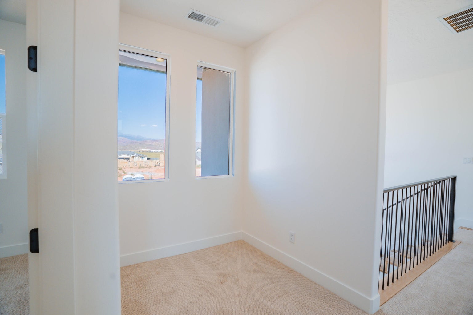 Unfurnished room featuring light colored carpet