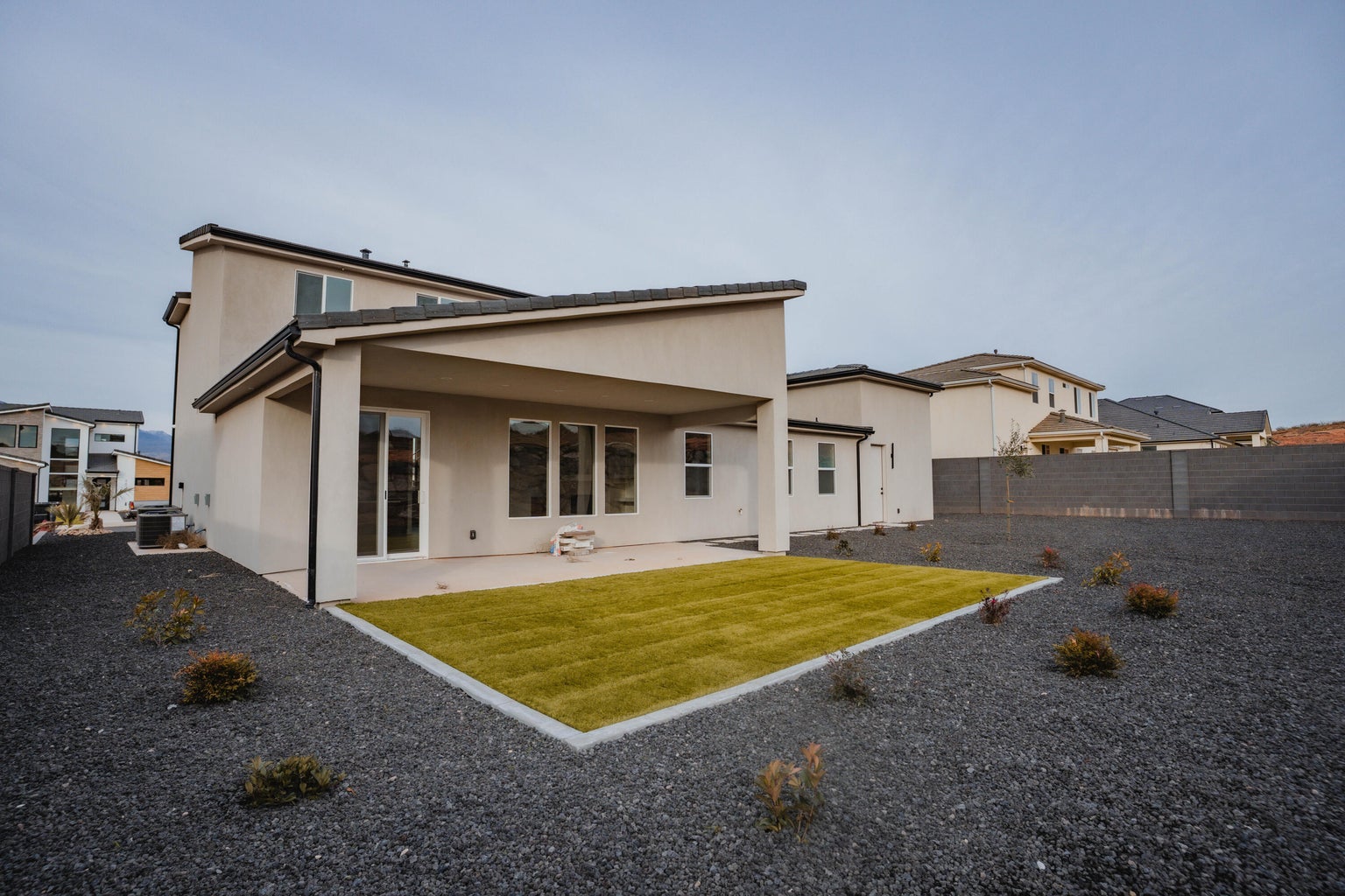 Rear view of property with a patio area, a fenced backyard, and stucco siding