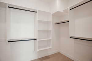 Spacious closet with light carpet