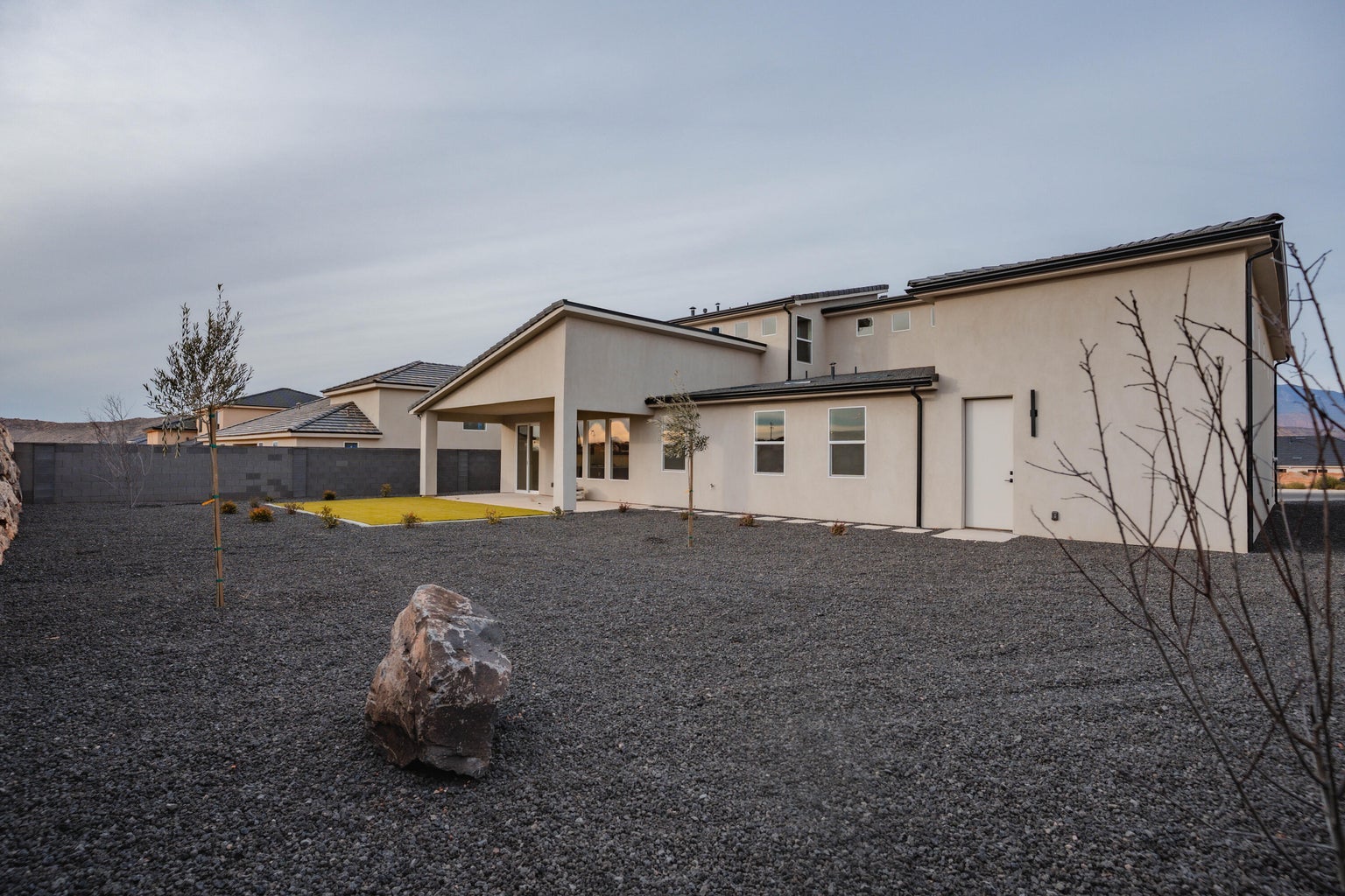 Back of house featuring stucco siding, a fenced backyard, and a patio area