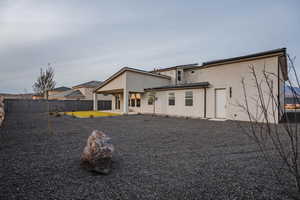 Back of house featuring stucco siding, a fenced backyard, and a patio area
