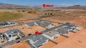 Aerial view of residential area featuring a mountain backdrop and a desert landscape