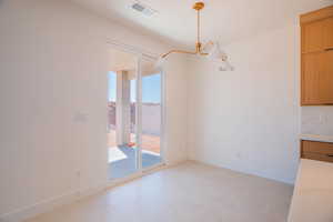 Unfurnished dining area featuring baseboards