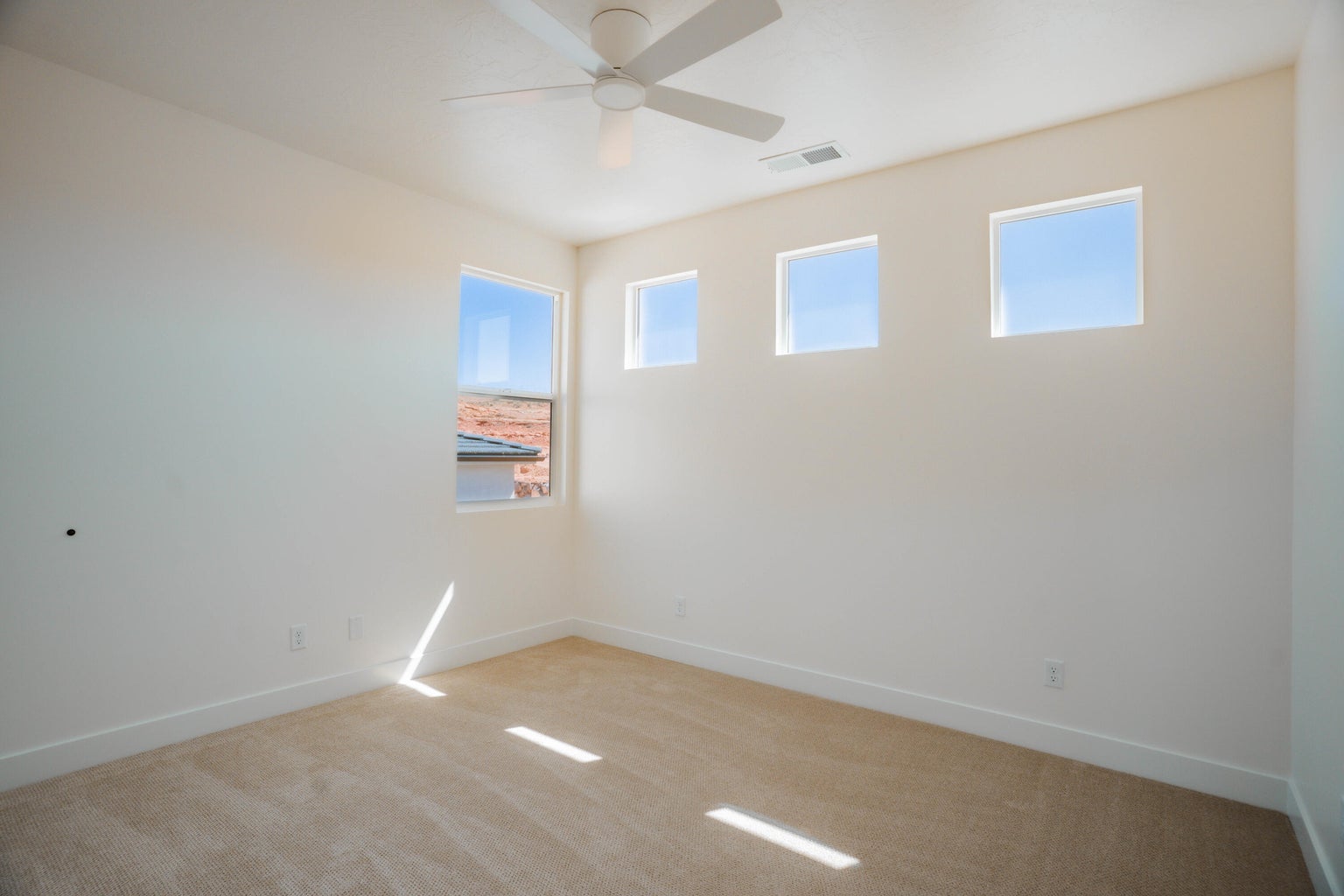 Spare room with light carpet and ceiling fan