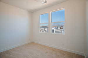 Carpeted spare room featuring baseboards and a ceiling fan