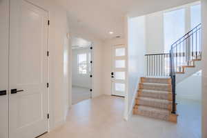 Foyer featuring stairs and recessed lighting