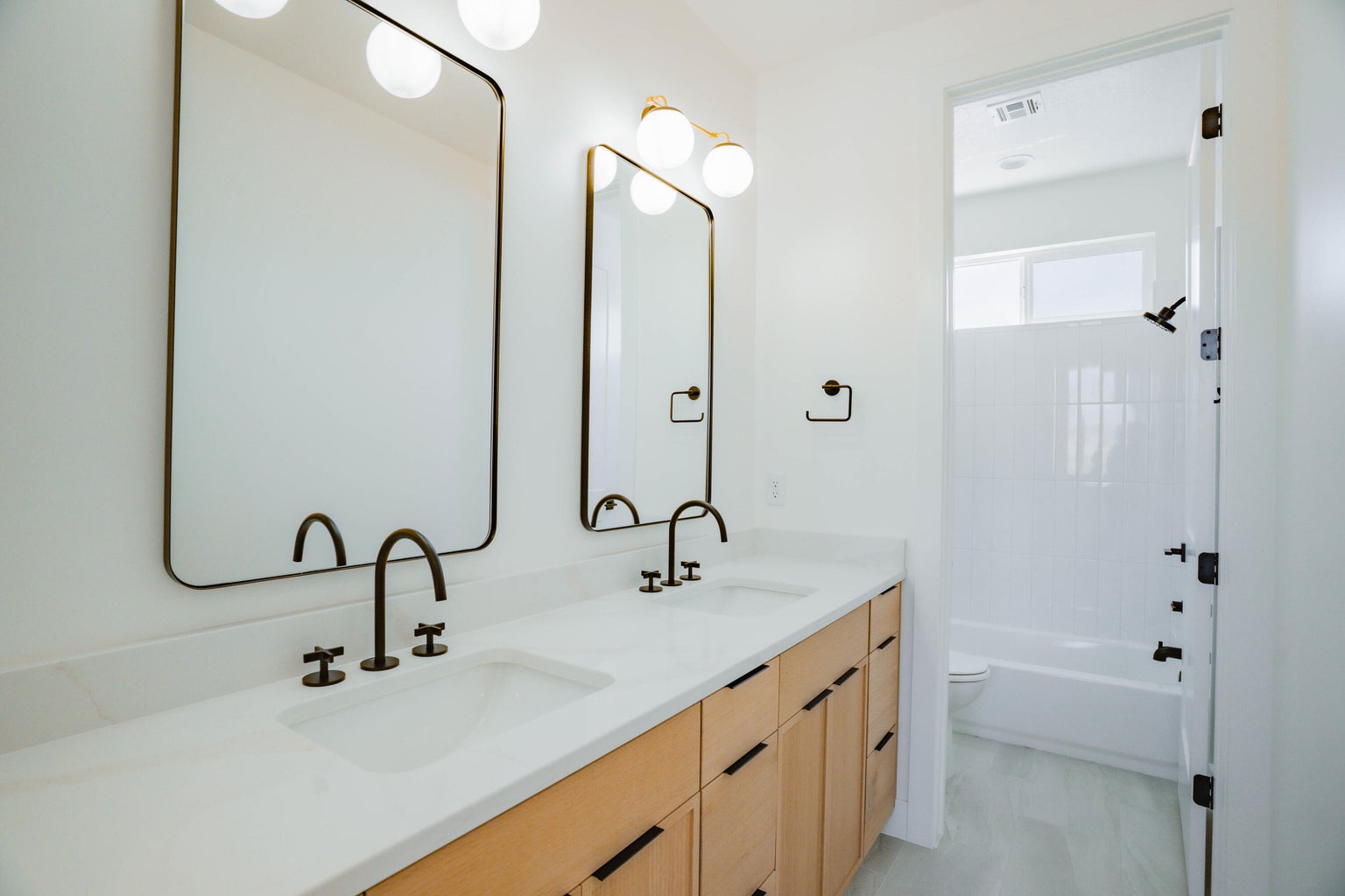 Full bath with double vanity and shower / tub combination