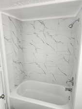 Full bathroom with shower / washtub combination
